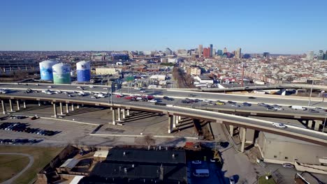 Ariel-shot-moving-to-the-right-along-interstate-95-during-commuter-rush-hour-with-the-Baltimore-city-skyline-in-the-background