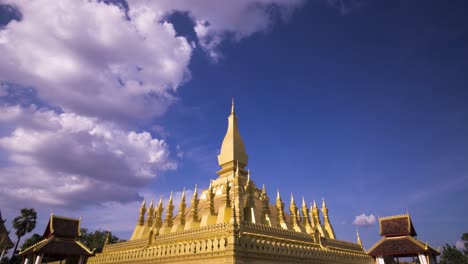 Pha-That-Luang-with-fluffy-clouds-and-blue-sky---zoom-in