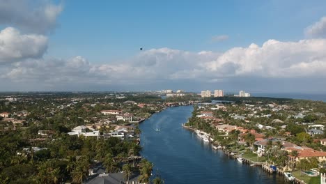 Aerial-shot-defending-along-the-intercostal-in-Florida-with-a-Blimp-near-by
