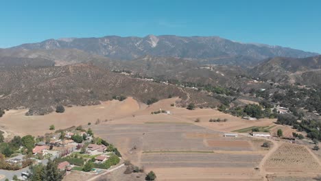 A-sweeping-drone-shot-of-the-hills-and-mountains-of-Riverside,-California-on-a-sunny-day