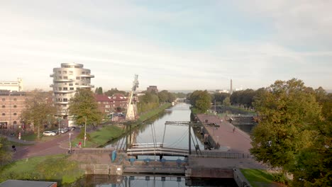Former-industrial-area-and-transportation-canal-in-the-city-of-Utrecht-now-reformed-into-a-green-neighbourhood-with-floating-houses,-recreational-areas-and-bike-path
