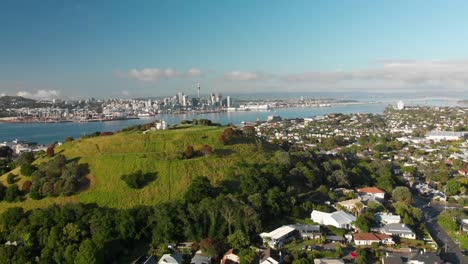 SLOWMO---Aerial-shot-of-Auckland-Sky-Tower-and-skyline,-New-Zealand