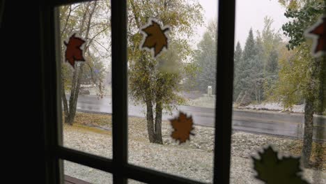 Shot-of-snow-falling-outside-through-a-door-window