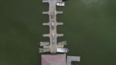 AERIAL:-Overhead-Drone-Shot-of-Dock-on-a-Green-Lake
