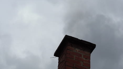 Smoke-and-chimney-against-sky