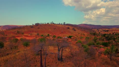 Aerial-drone-shot-flying-backwards-over-dry-dead-trees-near-a-small-village-in-rural-Bahia,-Brazil