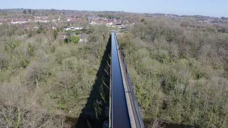 A-cyclist-walking-across-the-beautiful-narrow-Boat-canal-route-called-the-Pontcysyllte-Aqueduct-famously-designed-by-Thomas-Telford,-located-in-the-beautiful-Welsh-countryside,-bridge
