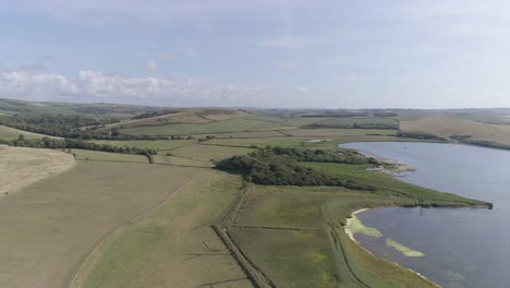Aerial-shot-tracking-from-right-to-left-revealing-the-fleet-lagoon-and-Swannery-between-Chesil-beach-and-the-village-of-Abbotsbury