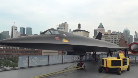 ZOOM-OUT---PAN,-Intrepid-Sea,-Air---Space-American-History-Museum-Fighter-aircraft-on-display-at-carrier-USS-Interpid-by-New-York