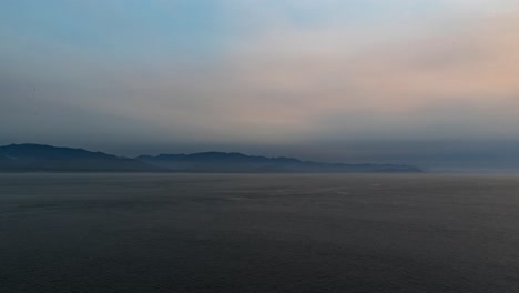 Time-lapse-of-the-open-water,-clouds,-and-distant-Alaska-mountains-from-a-ship