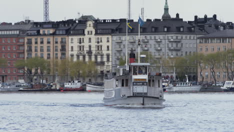 Tracking-Shot-of-Ferry-in-Old-City,-Galma-Stan,-Stockholm,-Sweden