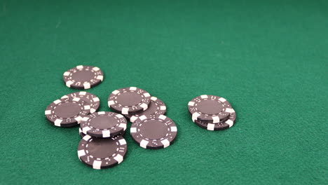 Poker-chips-dropping-onto-a-green-felt-table