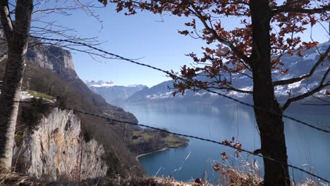 Wide-panorama-shot-of-o-fjord-lake-in-Switzerland-surrounded-by-cliffs