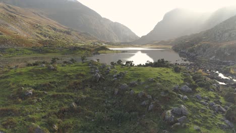 Aerial-of-stunning-epic-rocky-landscape-birds-flying-by,-at-lake,-mountains-and-greend-and-brown-thrilling-nature-gap-of-dunloe-ireland