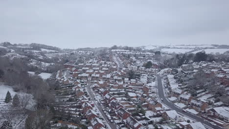 High-descending-drone-shot-of-snowy-Exeter-subburbs