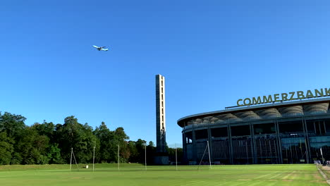 Airplane-flies-over-the-Commerzbank-arena-stadium-in-Frankfurt-Germany