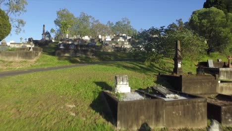 Aerial-drone-low-level-flyover-shot-of-graves,-rising-up-at-hillside