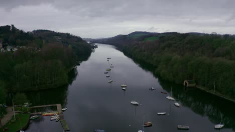 Beautiful-aerial-view,-footage-of-Rudyard-Lake-in-the-Derbyshire-Peak-District-Nation-Park,-popular-holiday,-tourist-attraction-with-boat-rides-and-water-sports-on-off,-peaceful,-calm-water