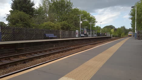 Static-Shot-of-Northern-Train-Arriving-at-Rural-Station-in-North-Yorkshire-on-a-Summer’s-Day