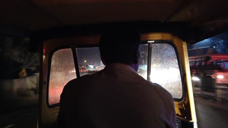 Wide-angle-timelapse-of-the-view-from-inside-of-an-autorickshaw-driving-through-traffic-during-night-time