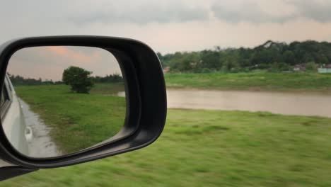 Driving-POV-View-Of-Sidemirror-With-Beautiful-Lake-And-Tree-Nature-Scenery