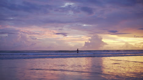 lone-burmese-fisherman-standing-in-the-ocean-with-a-fishnet-on-sunset-in-myanmar