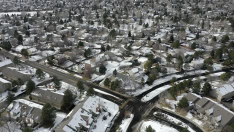 Drone-looks-over-snow-covered-neighborhood