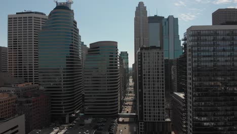 Aerial-footage,-downtown-Minneapolis-on-a-sunny-afternoon,-camera-approaching-to-buildings