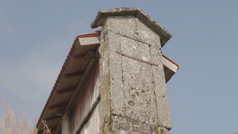 Low-angle-close-up-shot-of-a-granary-alled-espigueiro-in-a-rural-village-on-a-hill-Friaes-Tras-os-Montes-Portugal