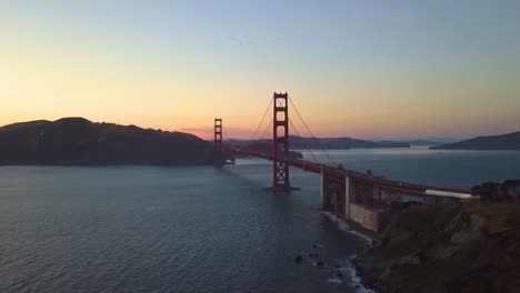 Dolly-In-as-a-Flock-of-Birds-Fly-above-Golden-Gate-Bridge-in-San-Francisco---4k