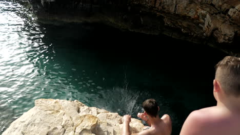 Young-man-makes-a-backflip-from-a-high-cliff-into-the-water
