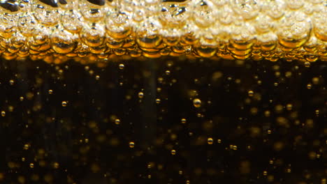 Slow-Motion-extreme-Closeup-Pouring-Apple-Cider-limonade,-black-background