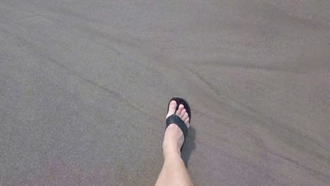 video-of-my-own-feet-walking-on-a-beach,-POV-footage-of-walking-on-beach