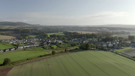 Aerial-view-of-the-Scottish-town-of-Fettercairn-on-a-sunny-Autumn-day,-Aberdeenshire