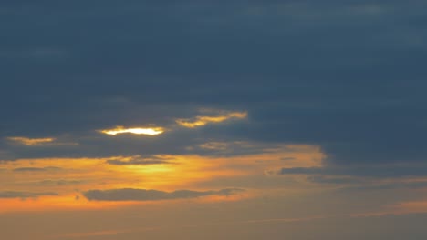 Beautiful-scenic-sunset-with-sun-shining-through-clouds,-wide-shot