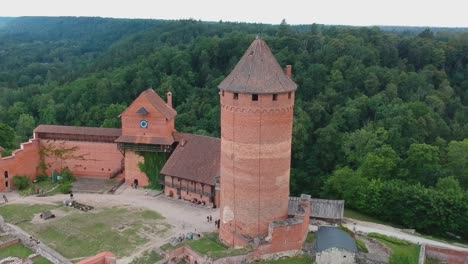 Aerial-shot-focus-on-the-main-tower-of-Turaida´s-Castle,-in-Latvia