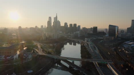 Aerial-view-of-Schuylkill-River,-highway,-and-Philadelphia-skyline-during-the-dawn-hour---sunrise
