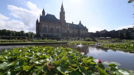 Garden-of-the-Peace-Palace,-the-seat-of-the-International-Court-of-Justice-under-a-sunny-and-cloudy-summer-day