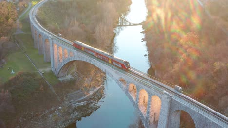 Aerial---Train-crossing-stone-arch-railrode-bridge,-Solkan-Slovenia