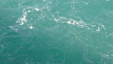 A-static-footage-from-top-showing-the-smooth-flow-of-blue-water-with-ripples-in-the-sea