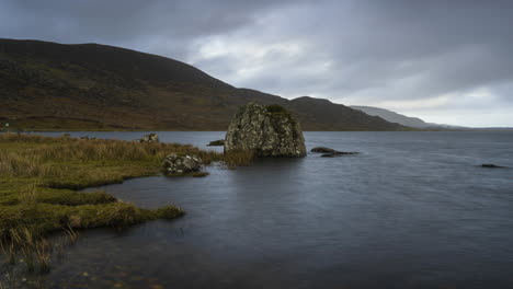 Time-Lapse-on-a-remote-lake-shore-on-dramatic-cloudy-day-in-Ireland
