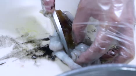 A-chef-cleans-squid.-Raw-seafood