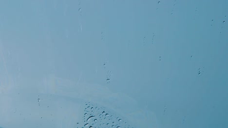 Windshield-wipers-wiping-off-raindrops-to-avoid-blurring-view---Close-up