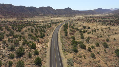 Aerial-view-of-interstate-highway-and-cars-during-a-road-trip-in-the-dry-and-rugged-desert-of-Utah-in-the-American-Southwest