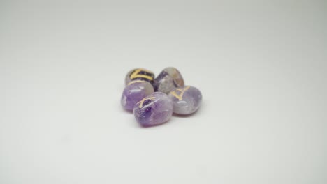 A-Beautiful-Purple-Colored-Gem-Stones-With-Yellow-Mark-On-The-Top-Rotating-Slowly---Close-Up-Shot