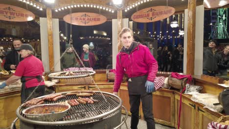 Christmas-market-German-sausage-street-food-vendor-cooking---serving-hot,-tasty-savoury-foods