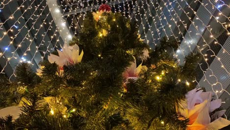 Hanging-Garlands-Revolve-Around-Christmas-Tree-In-Modern-Building