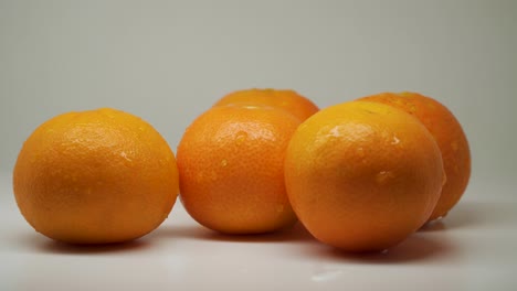 Five-Sweet-Oranges-At-The-Top-Of-The-Table-With-White-Background---Close-Up-Shot