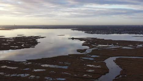 An-aerial-shot-of-Baldwin-Bay-near-Freeport,-NY-at-sunset