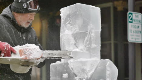 Ice-sculptor-using-chainsaw-on-block-of-ice